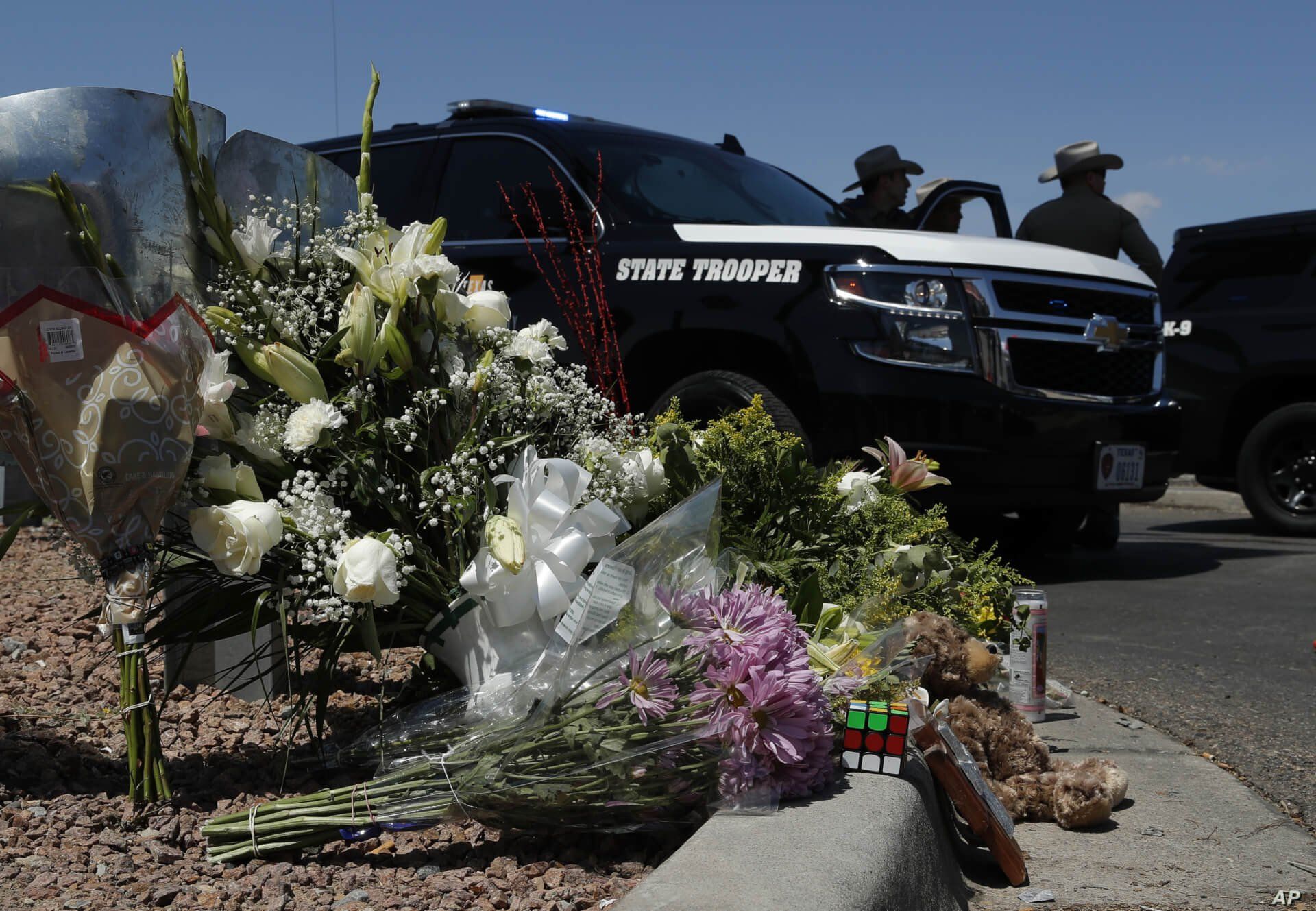 Flowers adorn a makeshift memorial near the scene of a mass shooting at a shopping complex in El Paso, Texas, Aug. 4, 2019.