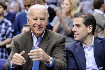 FILE - In this Jan. 30, 2010, file photo, Vice President Joe Biden, left, with his son Hunter, right, at the Duke Georgetown…