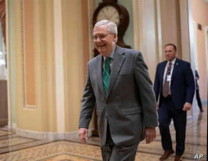 Senate Majority Leader Mitch McConnell, R-Ky., walks to the Senate chamber at the Capitol in Washington, Thursday, Feb. 13,…