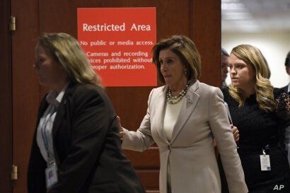 FILE - House Speaker Nancy Pelosi is seen walking with aides on Capitol Hill in Washington, Oct. 17, 2019.