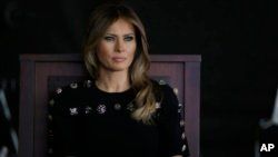 FILE - First lady Melania Trump sits as President Donald Trump addresses U.S. military troops and their families at the Sigonella Naval Air Station, in Sigonella, Italy, May 27, 2017.