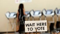 Pamela Hampton votes in Sandy Springs, Ga., May 9, 2018. Voting and cybersecurity experts say that if voting machines do not produce paper records of votes cast, double-checking the results for signs of manipulation is much more difficult.