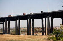 Traffic moves along a bridge as seen from a train in New Jersey, May 18, 2021.