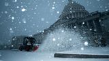 Fast moving winter storm blankets Washington with snow, closing government, schools