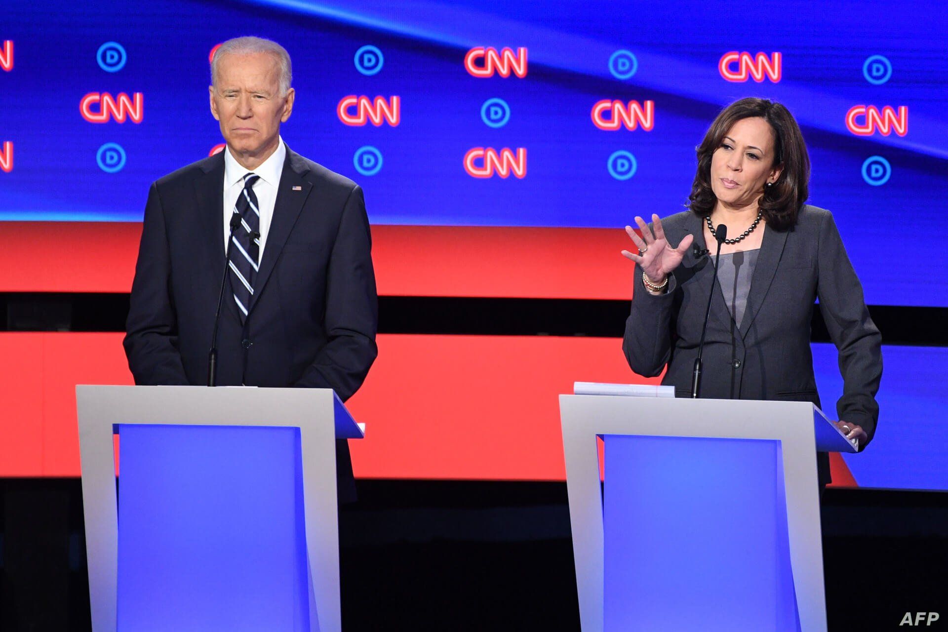  Democratic presidential hopeful U.S. Senator from California Kamala Harris, right, delivers her closing statement flanked by former Vice President Joe Biden during the Democratic primary debate hosted by CNN at the Fox Theatre in Detroit, July 31, 2019. 