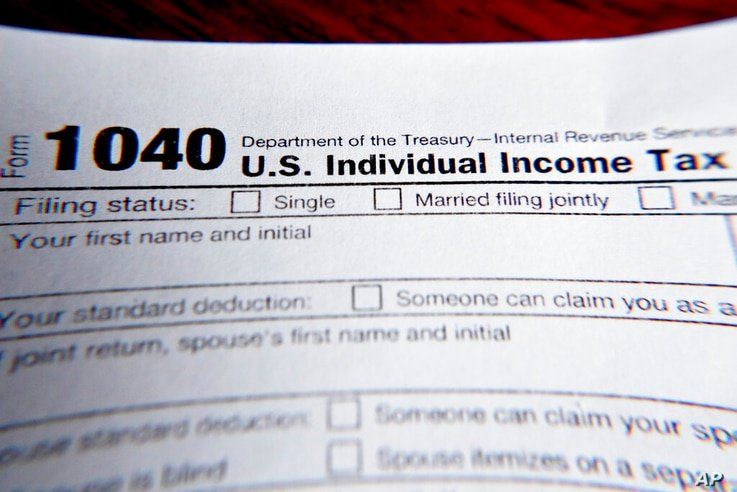 FILE - This Wednesday, Feb. 13, 2019 file photo shows part of a 1040 federal tax form printed from the Internal Revenue Service…