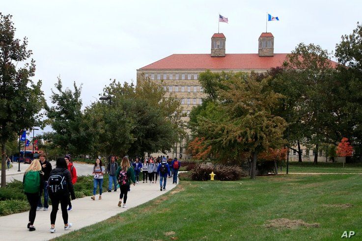 FILE - In this Oct. 24, 2019, file photo students walks in front of Fraser Hall on the University of Kansas campus in Lawrence,…
