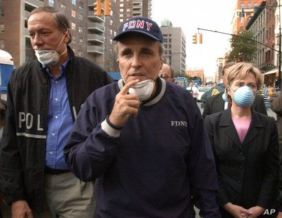 FILE - In this Wednesday, Sept. 12, 2001 file photo, New York City Mayor Rudolph Giuliani, center, leads New York Gov. George Pataki, left, and Sen. Hillary Clinton, D-N.Y., on a tour of the site of the World Trade Center disaster. While stumping…