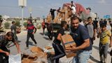 More than 100 killed in Gaza after thousands rush aid trucks, officials say