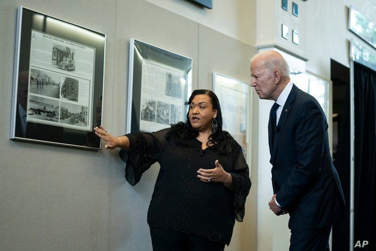 Michelle Brown-Burdex, program coordinator of the Greenwood Cultural Center, speaks as she leads President Joe Biden on a tour of the center to mark the 100th anniversary of the Tulsa race massacre, June 1, 2021, in Tulsa, Oklahoma.
