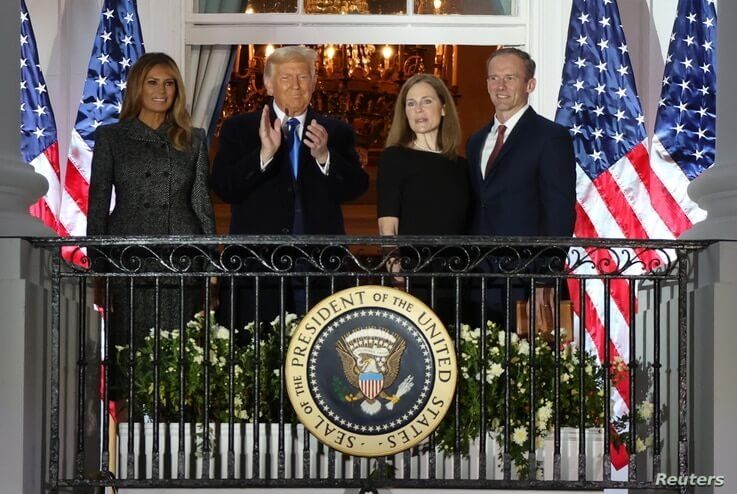 U.S. Supreme Court Associate Justice Amy Coney Barrett poses with first lady Melania Trump, President Donald Trump 