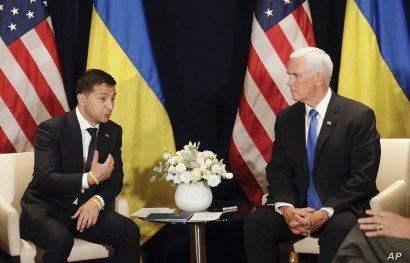 Ukraine's President Volodymyr Zelenskiy, left, gestures next to U.S. Vice President Mike Pence, during a bilateral meeting in Warsaw, Poland, Sunday, Sept. 1, 2019. 