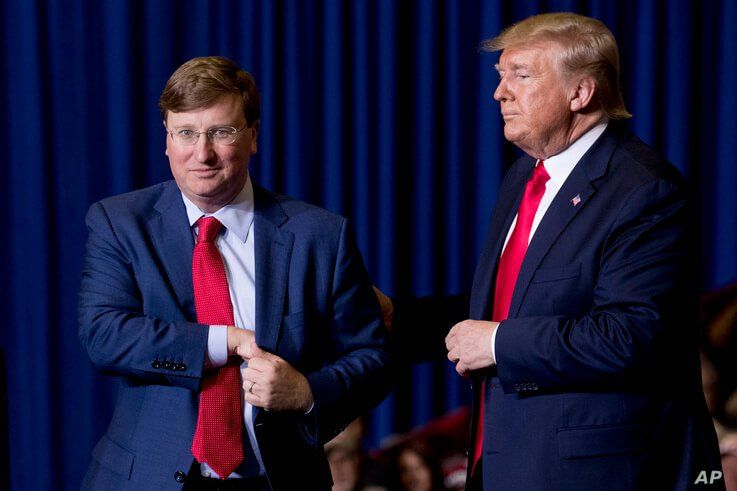President Donald Trump welcomes Mississippi Lt. Gov. Tate Reeves, left, to the stage at a rally at BancorpSouth Arena in Tupelo…