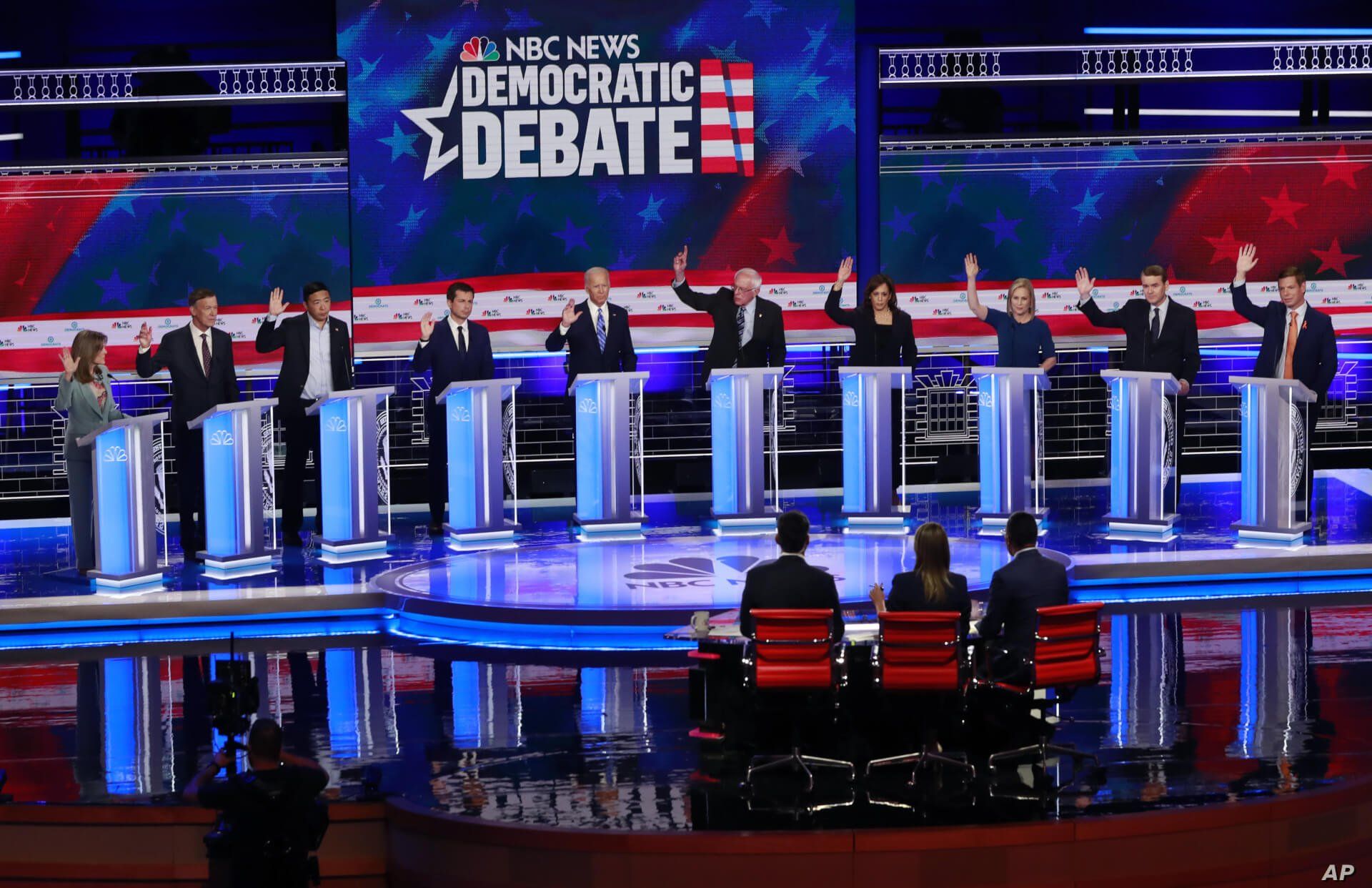 Democratic presidential candidates raise their hands during the Democratic primary debate at the Adrienne Arsht Center for the Performing Arts in Miami, Florida, June 27, 2019.