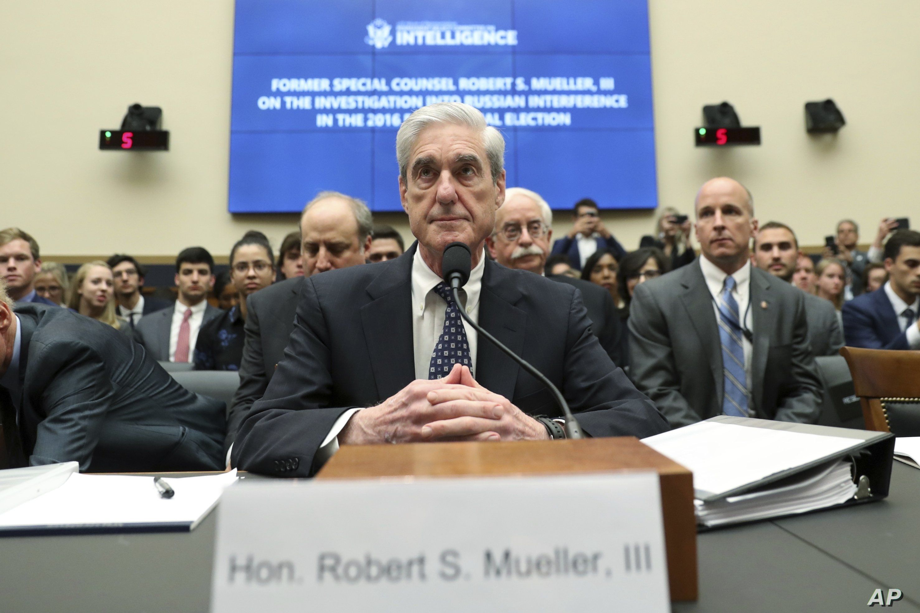 Former special counsel Robert Mueller listens to committee members give their opening remarks before he testifies before the House Intelligence Committee on his report on Russian election interference, on Capitol Hill, in Washington, July 24, 2019.