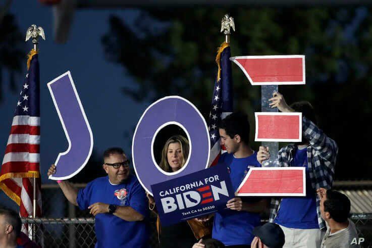 Supporters hold a sign before a campaign rally for Democratic presidential candidate former Vice President Joe Biden, March 3, 2020, in Los Angeles. 