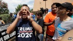 FILE - A man who called himself a citizen taxpayer, left, argues with protesters at a a rally to oppose a new Texas "sanctuary cities" bill that aligns with the president's tougher stance on illegal immigration, June 26, 2017, in San Antonio, outside of t