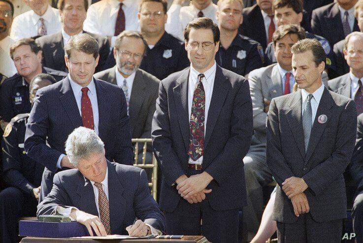 FILE - President Bill Clinton signs the $30 billion crime bill during a ceremony on the South Lawn of the White House in Washington.