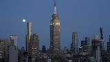 Two people climb to the top of Empire State Building and raise banner: 'power of love'