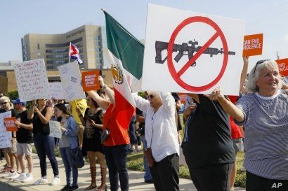 FILE - Demonstrators gather to protest after a mass shooting that occurred in Dayton, Ohio, Aug. 7, 2019.