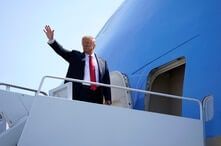 President Donald Trump waves as he boards Air Force One for a trip to Arizona to visit the border and deliver a speech 