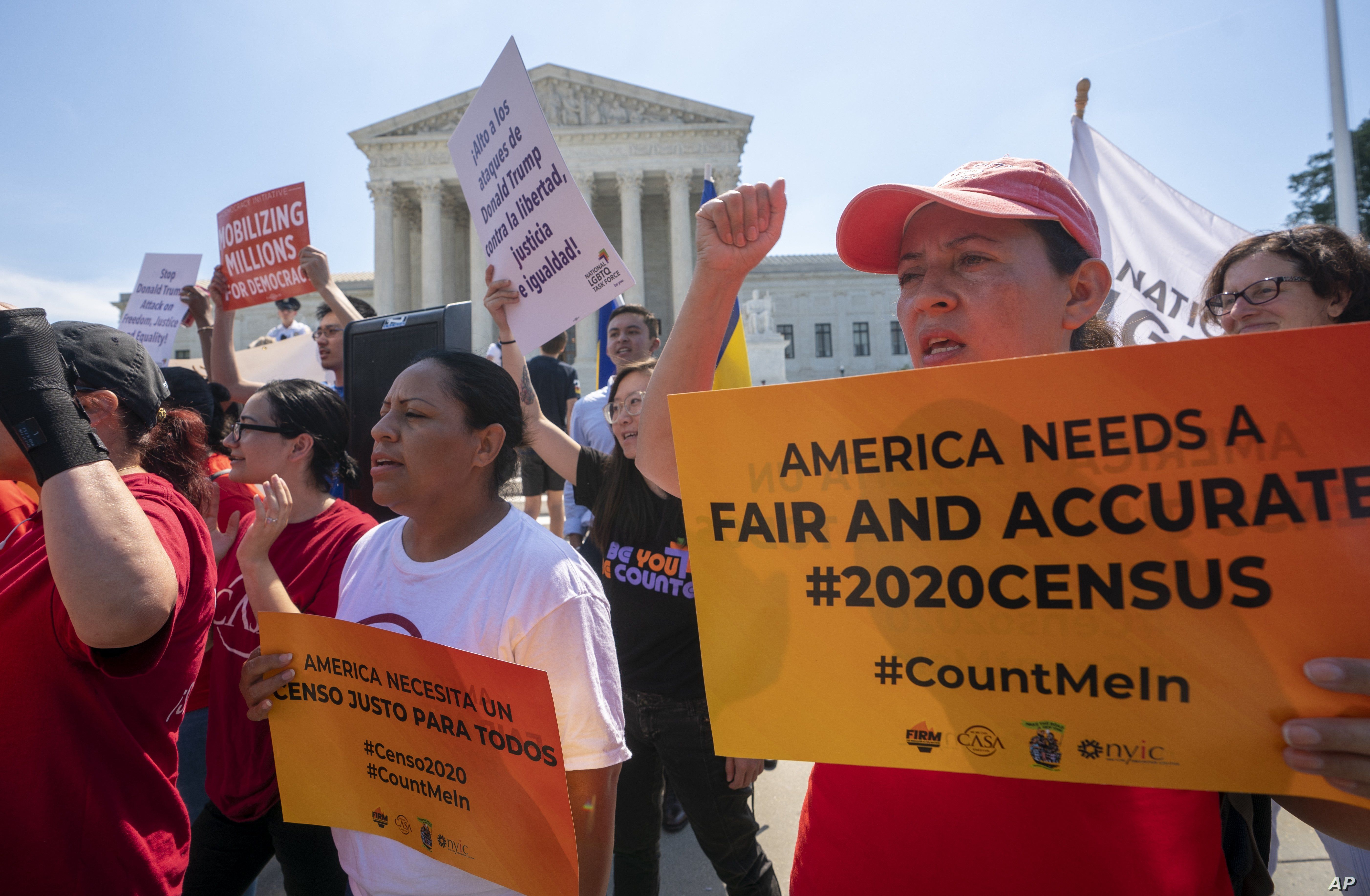 Demonstrators are seen at the Supreme Court as justices deliberate on a census case involving an attempt by the Trump administration to include a citizenship question in the 2020 census, on Capitol Hill in Washington, June 27, 2019.