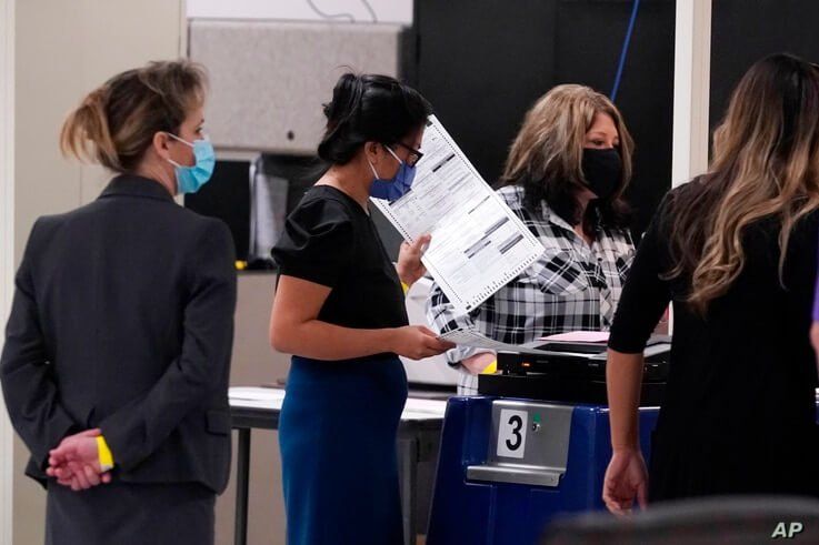 The Maricopa County Elections Department officials conduct a post-election logic and accuracy test for the general election as observers watch the test, Nov. 18, 2020, in Phoenix, Arizona.