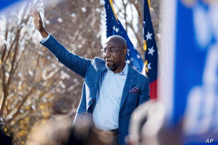 Democratic U.S. Senate challenger the Rev. Raphael Warnock during a rally, Monday, Dec. 21, 2020 in Columbus, Ga. with Vice…