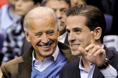 FILE - Then-U.S. Vice President Joe Biden and his son Hunter Biden attend an NCAA basketball game between Georgetown University and Duke University in Washington, Jan. 30, 2010. 