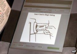 This photo shows a touchscreen of a voting machine during early voting in Sandy Springs, Ga., May 9, 2018. The fact that many voting machines used by Americans do not produce paper records worries cybersecurity experts.