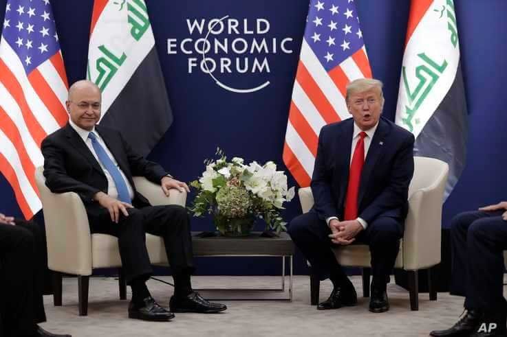 US President Donald Trump, right, attends a meeting with his Iraqi counterpart Barham Salih at the World Economic Forum.