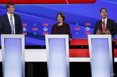Democratic presidential candidate former Texas Rep. Beto O'Rourke, left, Sen. Amy Klobuchar, D-Minnesota, and former Housing Secretary Julian Castro participate in a Democratic presidential primary debate hosted by CNN/New York Times at Otterbein University, in Westerville, Ohio, Oct. 15, 2019. 