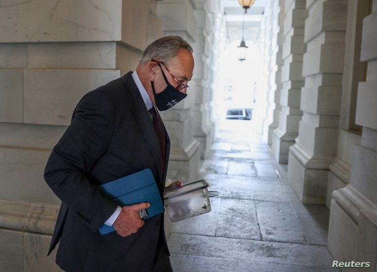 U.S. Senate Majority leader Chuck Schumer (D-NY) carries his empty lunch box back into the Capitol as the Senate continues to…