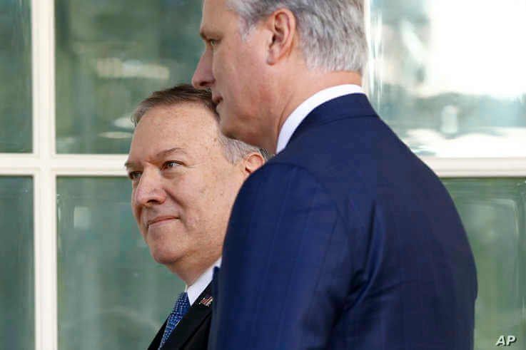 FILE - Secretary of State Mike Pompeo, back left, and National Security Adviser Robert O'Brien head to the Oval Office of the White House, in Washington, Nov. 25, 2019.