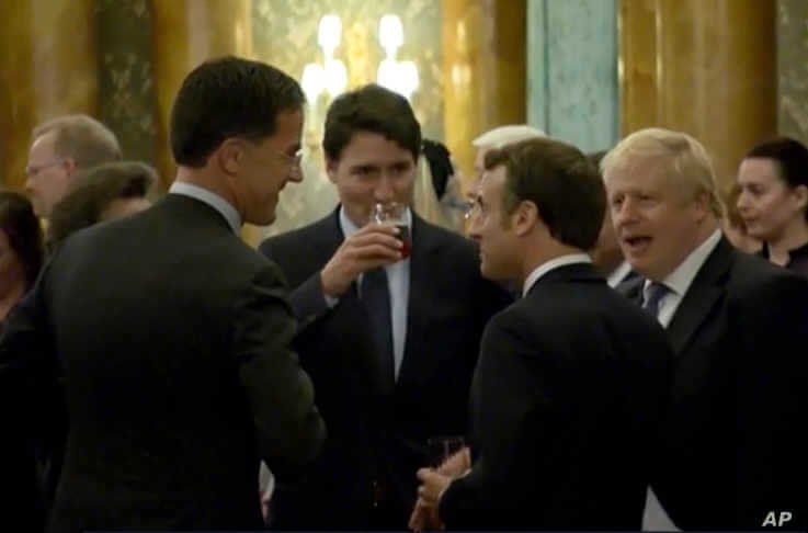 In this grab taken from video on Dec. 3, 2019, Britain's Prime Minister Boris Johnson, right, speaks during a party.