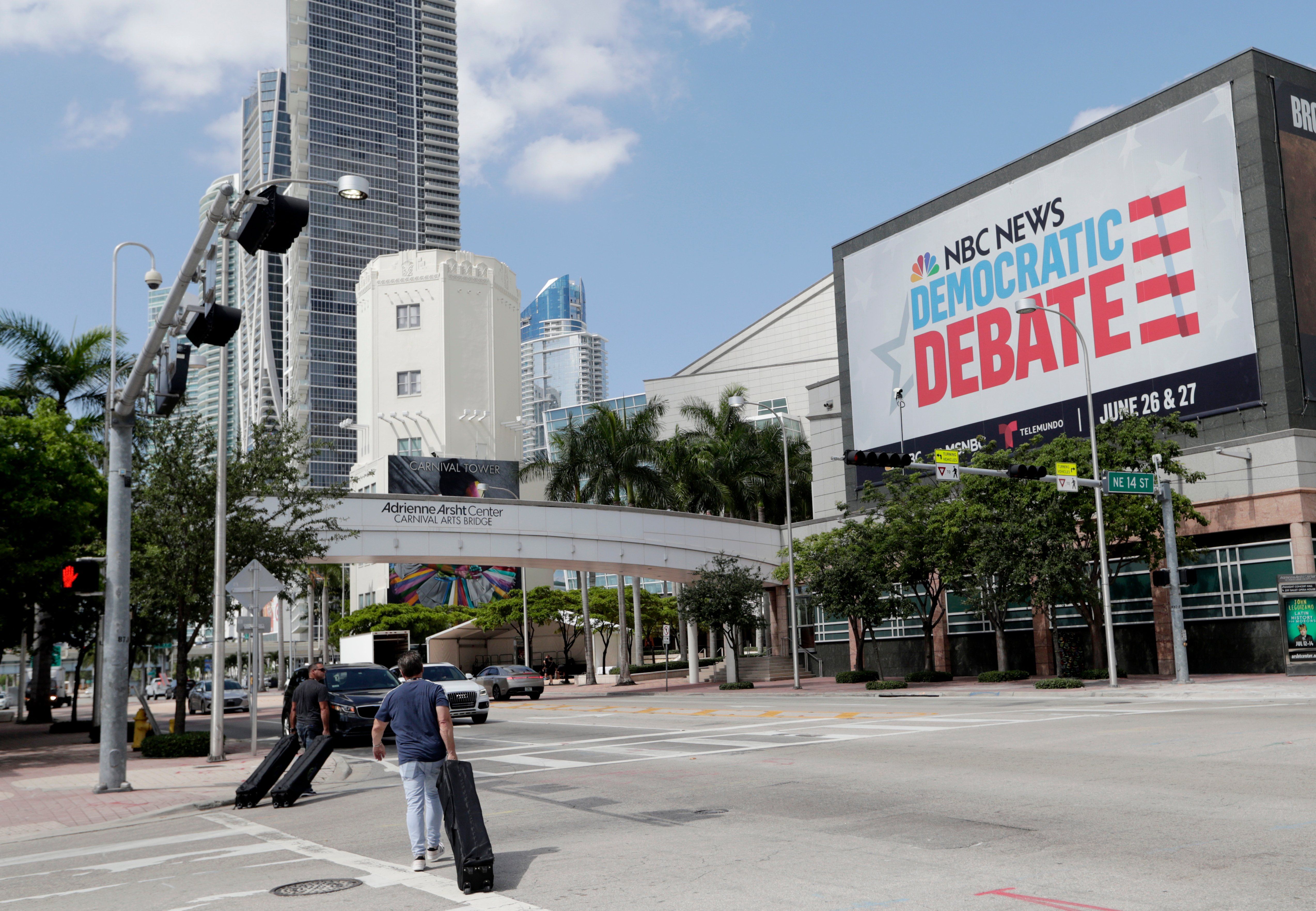 In this June 24, 2019, photo, a billboard advertises the Democratic Presidential Debates across from the Knight Concert Hall at the Adrienne Arsht Center for the Performing Arts of Miami-Dade County, in Miami. 