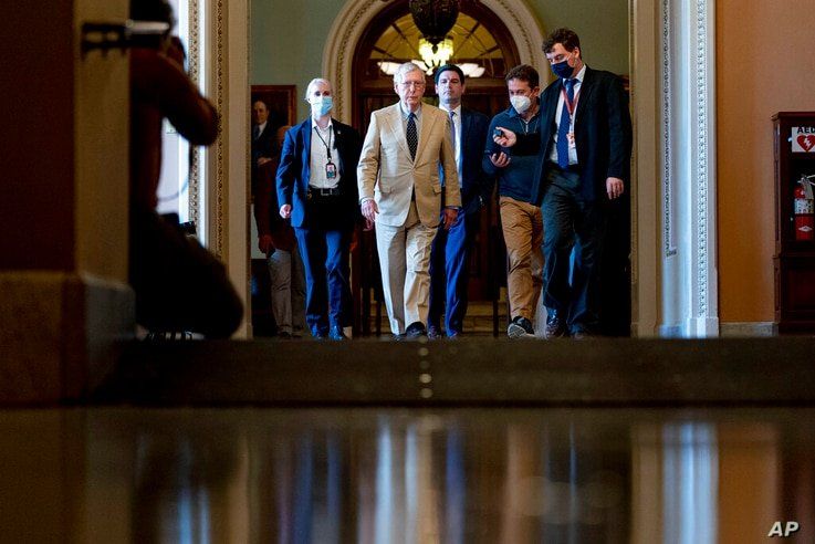 Senate Minority Leader Mitch McConnell of Ky. walks off the Senate floor as the $1 trillion bipartisan infrastructure bill gets…
