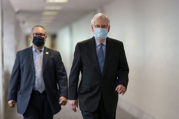 Senate Majority Leader Mitch McConnell, R-Ky., arrives for a closed-door meeting with fellow Republicans as they work toward…