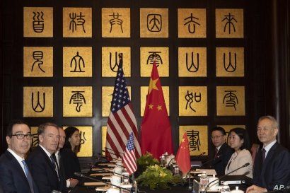Chinese Vice Premier Liu He, right, sits with U.S. Trade Representative Robert Lighthizer, second from left, and Treasury Secretary Steven Mnuchin, left, before the start of talks at the Xijiao Conference Center in Shanghai, July 31, 2019.