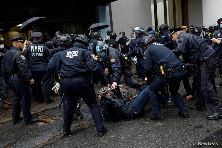 A man is detained while Black Lives Matter members and people confront NYPD during a march against far right movement and Trump…