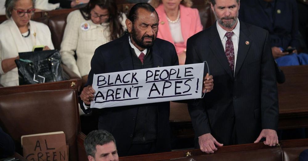 Rep Al Green escorted from House chambers after holding up sign reading: 'Black People Aren't Apes'
