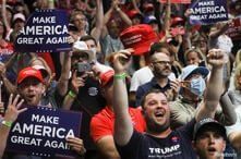 Supporters of U.S. President Donald Trump, most of them not wearing protective face masks, cheer for him 