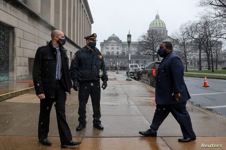 Electoral College member Pennsylvania State Representative Jordan Harris (D-Philadelphia) arrives at an entrance secured by…