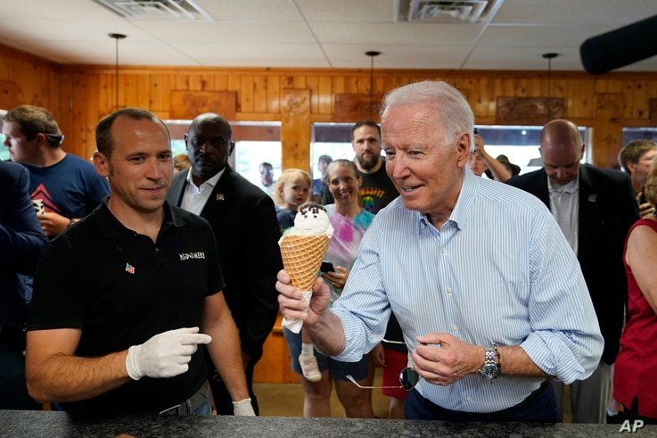 President Joe Biden holds an ice cream cone as he visits Moomers Homemade Ice Cream in Traverse City, Mich., July 3, 2021.