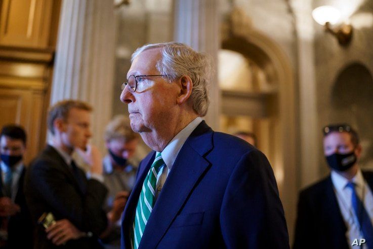 Senate Minority Leader Mitch McConnell, R-Ky., walks past the chamber as the Senate advances to formally begin debate on a…