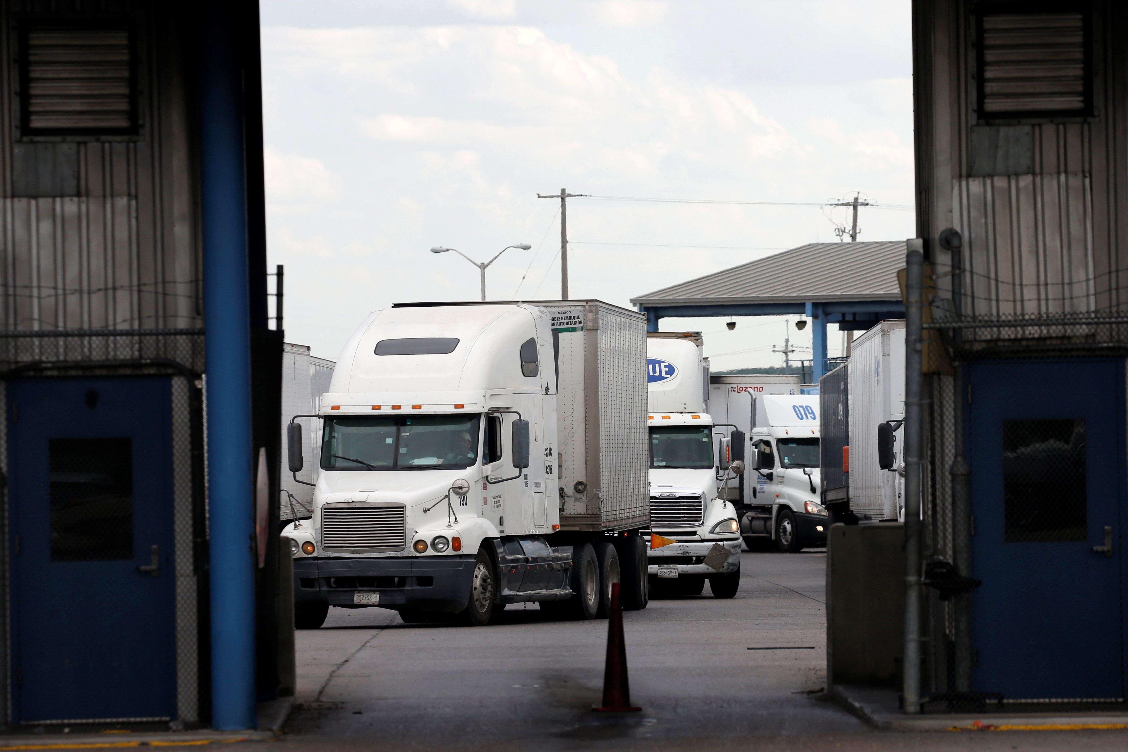 Trucks are seen after crossing the borderline from Mexico into the U.S. at the World Trade Bridge, in Laredo