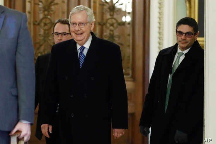 Senate Majority Leader Mitch McConnell, R-Ky., walks past the entrance to the Senate chamber as he arrives at his office