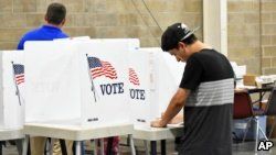 Devin Asbell fills out his primary election ballot at MetraPark Arena in Billings, Mont., June 5, 2018.