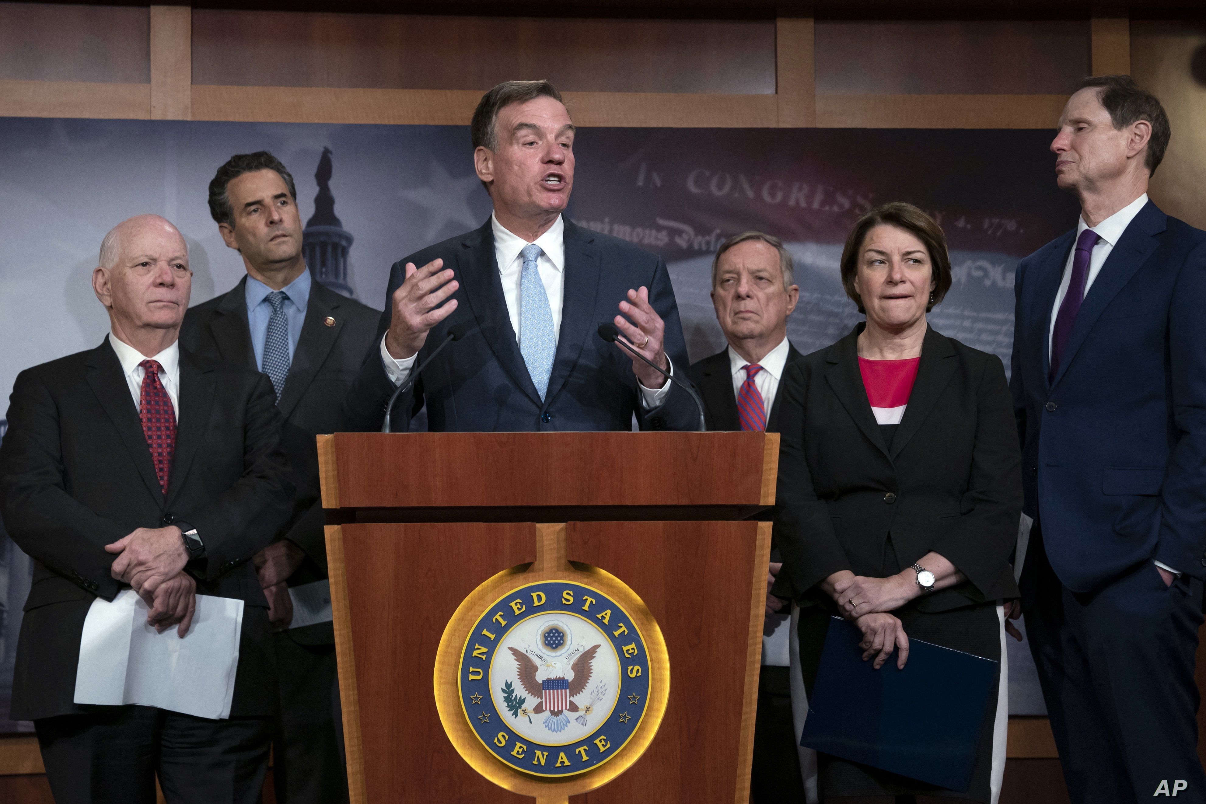 Sen. Mark Warner, D-Va., vice-chair of the Senate Intelligence Committee, is joined by fellow Democrats as he tells reporters that the Republicans have killed every piece of legislation the Democrats have crafted to protect elections, during a news…