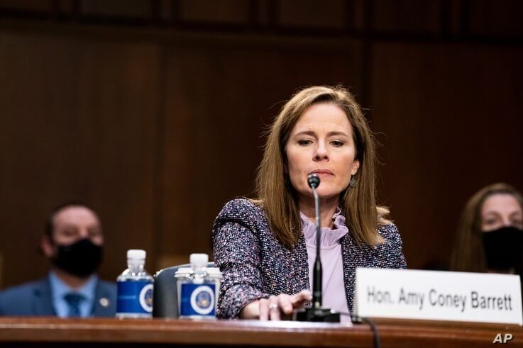 Supreme Court nominee Amy Coney Barrett tests her microphone during a confirmation hearing before the Senate Judiciary Committee, Capitol Hill in Washington, Oct. 14, 2020.